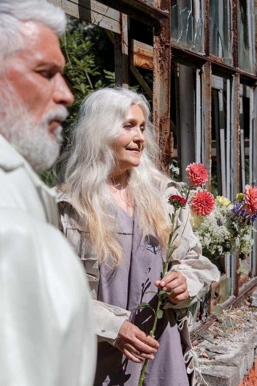 Evelyn Gardener smiling with her flower arrangement